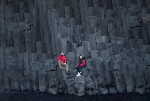 Walk under a cliff of black stone stacked like organ pipes